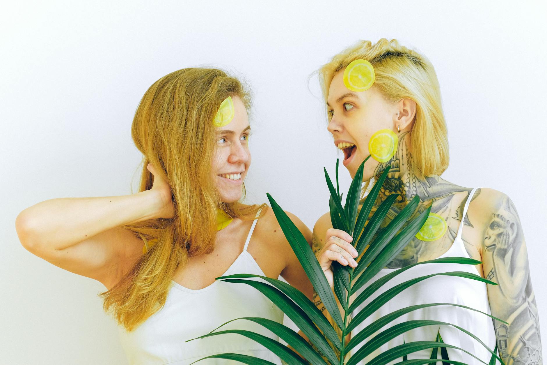 Two women laughing together indoors with joy and natural light