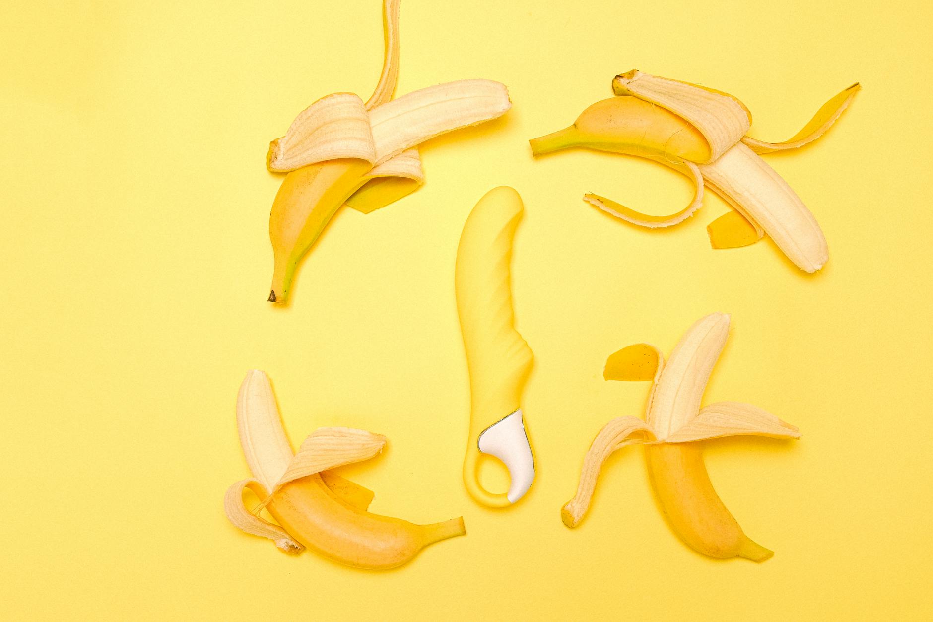 Bright yellow lemon clitoral vibrator on warm yellow background symbolizing pleasure and relaxation