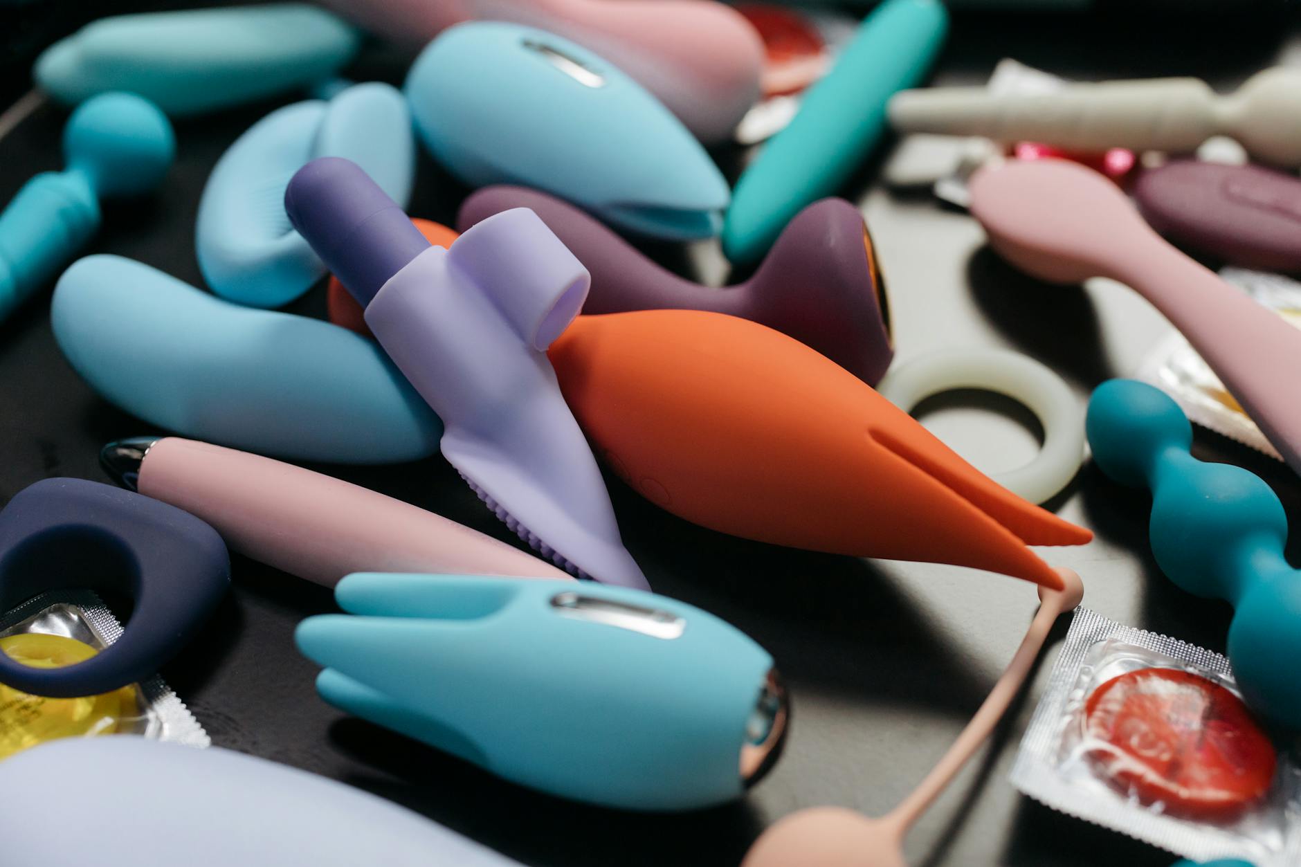Close-up of colorful vibrators and adult wellness toys displayed together